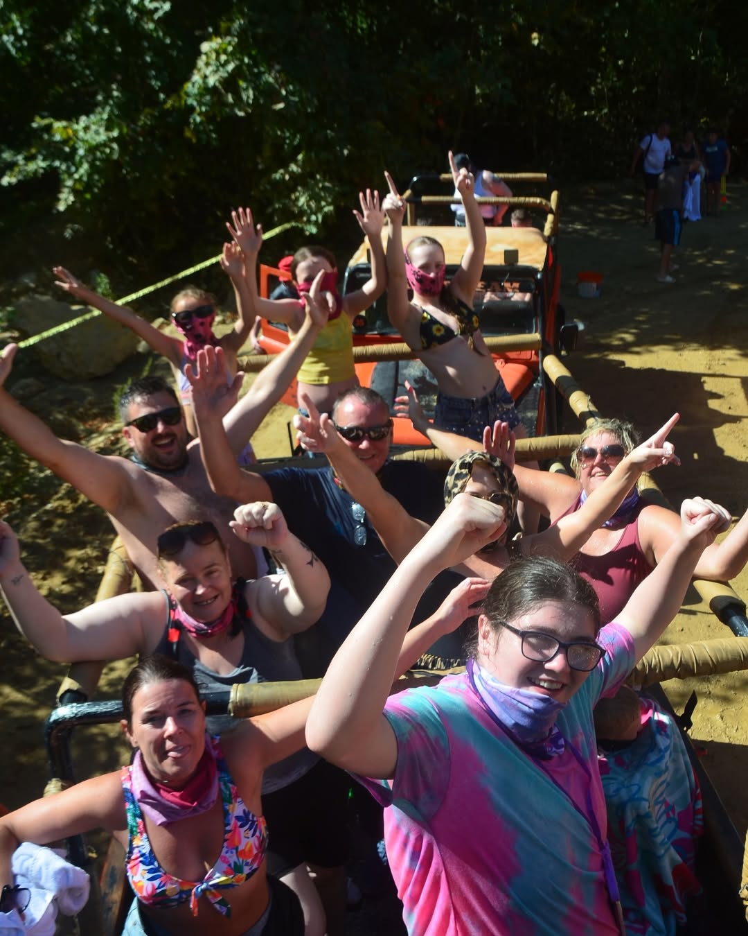 Tourist group celebrating after water fight on jeep safari near Zeus Cave, Kusadasi